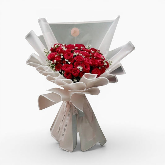 The Flowercart's Scarlet bouquet: 50 red roses with baby's breath, elegantly wrapped. Perfect for romance.