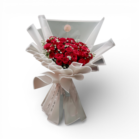The Flowercart's Scarlet bouquet: 50 red roses with baby's breath, elegantly wrapped. Perfect for romance.