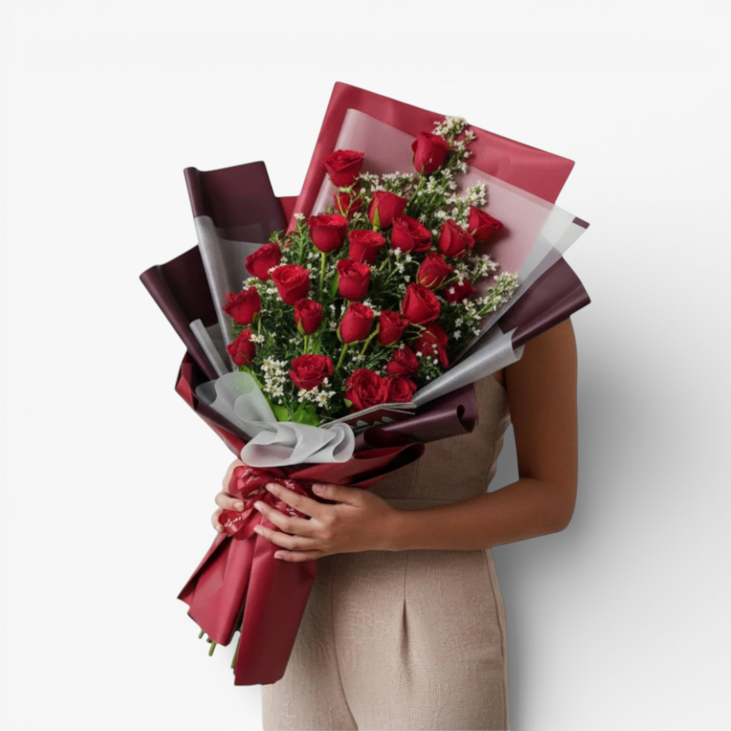 The Flowercart's Crimson Whisper bouquet: 24 red roses with white filler flowers, wrapped in burgundy and red paper, tied with a ribbon.
